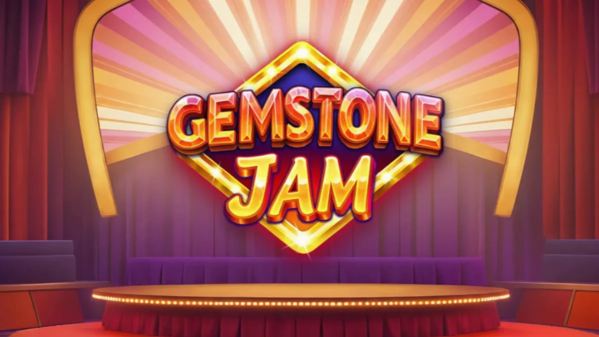 Tampilan visual mesin slot Gemstone Jam dengan simbol klasik dan latar belakang panggung TV yang mewah.